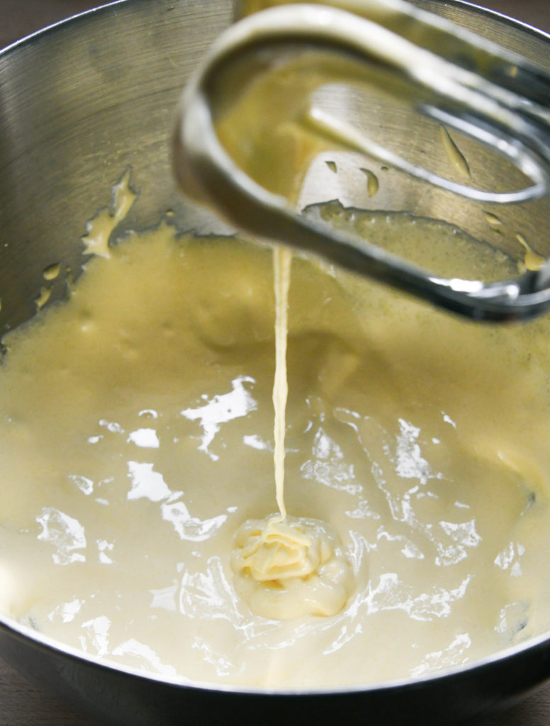 a ribbon of custard dripping from the beater