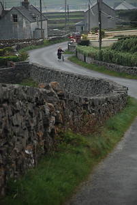 Woman pushing bike uphill on Inishmore