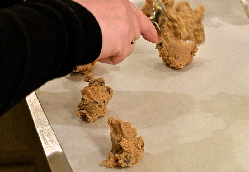 putting cookie dough on a baking sheet