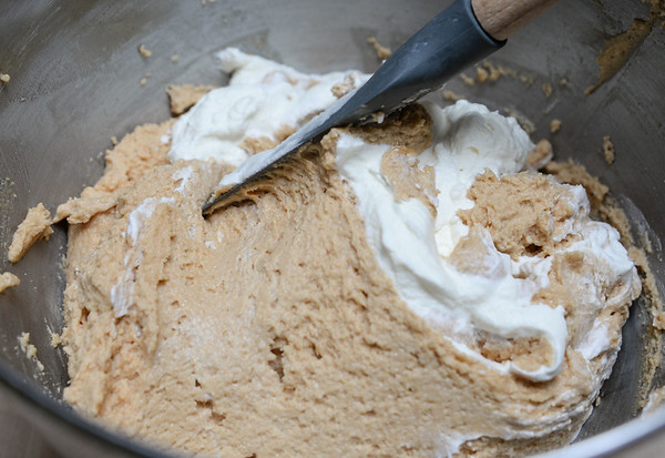 Folding whipped cream into the peanut butter-cream cheese filling