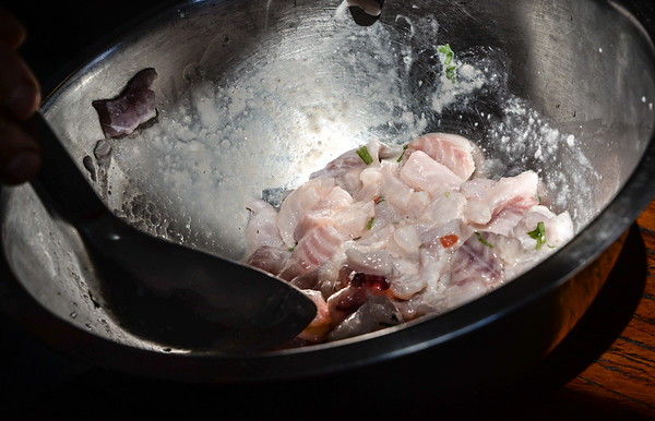 mixing together ceviche